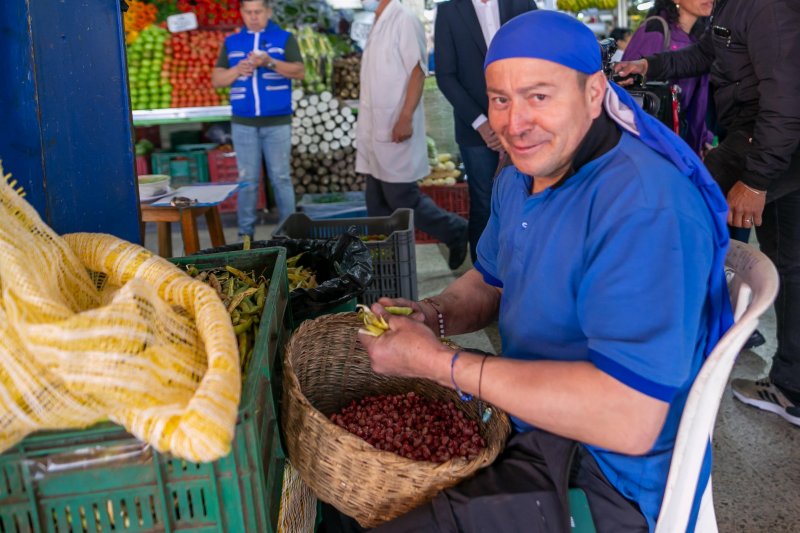 Foto de emprendedor en puesto de frutas y verduras